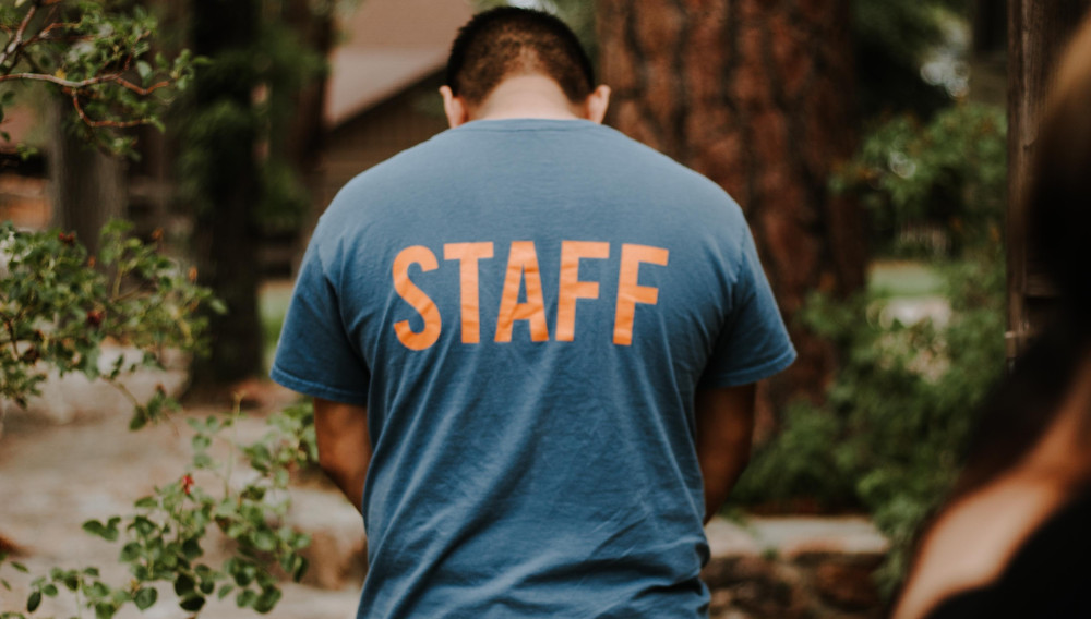 Man with STAFF shirt (Photo: Omar Lopez on Unsplash)