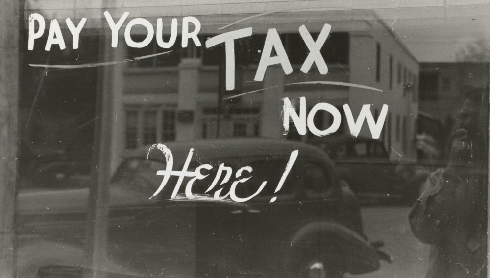 "Pay your tax now" written on a window (Photo: The New York Public Library)